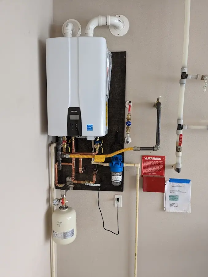 Professional plumber installing copper piping in a Brownsburg home